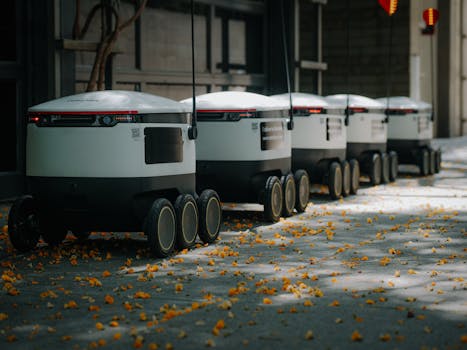 Futuristic delivery robots lined up outdoors, showcasing innovative modern technology.